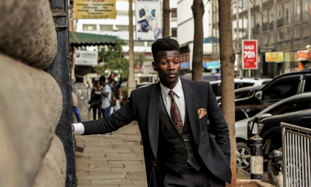 Well-dressed man in a suit posing on a busy urban street in Nairobi, Kenya.